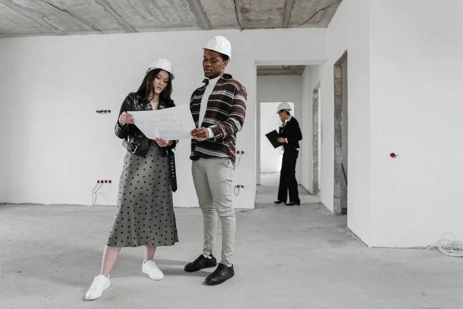 Architect and client reviewing renovation drawings together