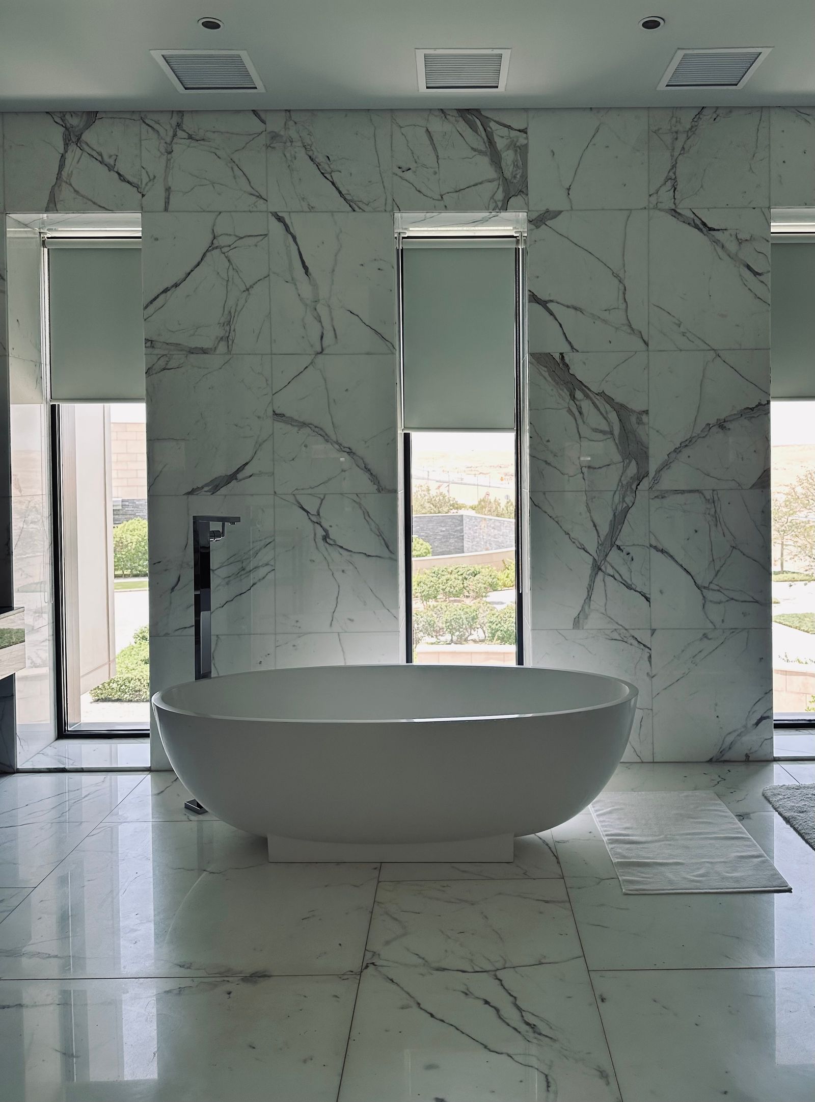 Spa-style bathroom remodel with soaking tub and natural stone tile