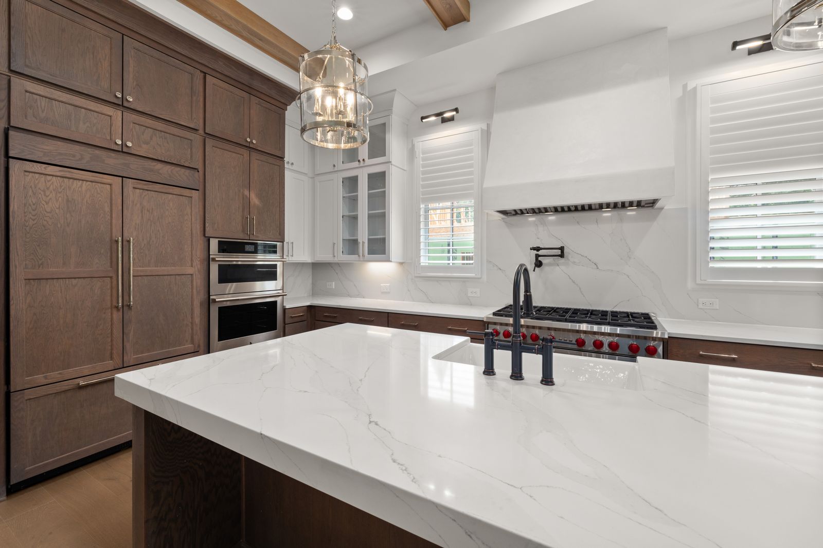 Modern kitchen remodel with natural wood cabinetry and stone countertops
